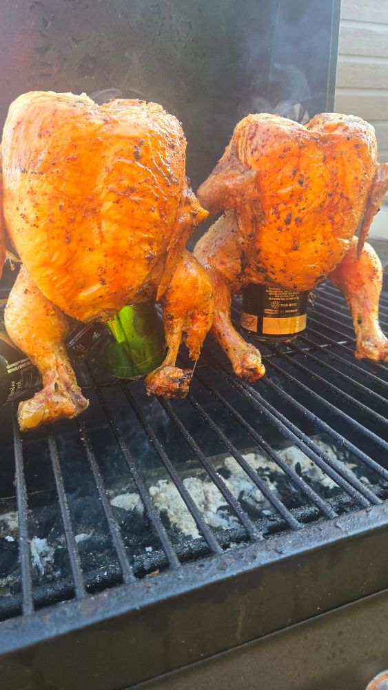 2 beerbutt chickens cooking on a barbecue 