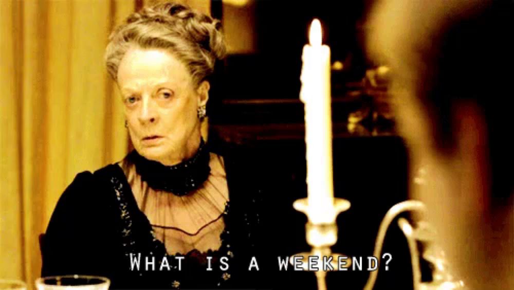 a woman sitting at a table with a candle and the words " what is a weekend " above her