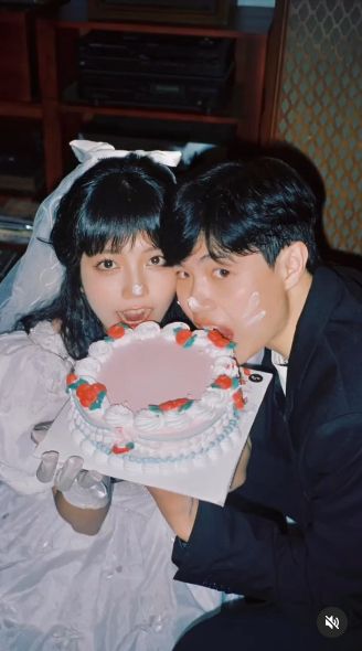 A very cute couple that are sharing a cake.