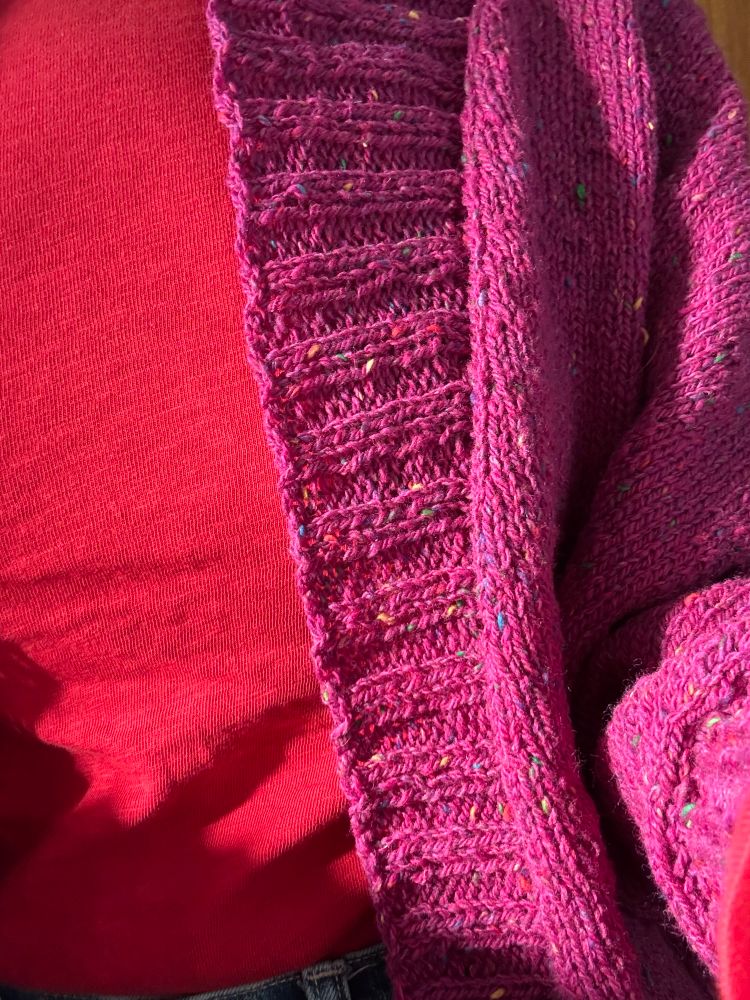 My very fuchsia sweater over a red top in the sunlight.