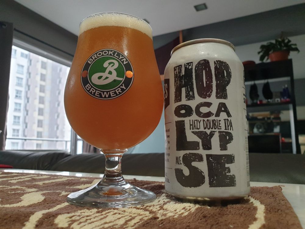 A chilled glass of Drakes Hopocalypse Double IPA next to its can. Mmmm