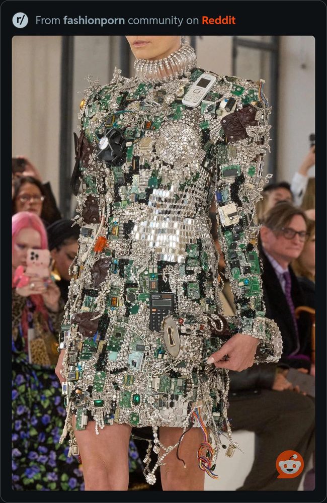 A short dress embellished with sequins, jewels, and electronic junk. 