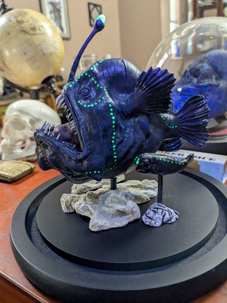 Huge female anglerfish model next to her tiny husband 