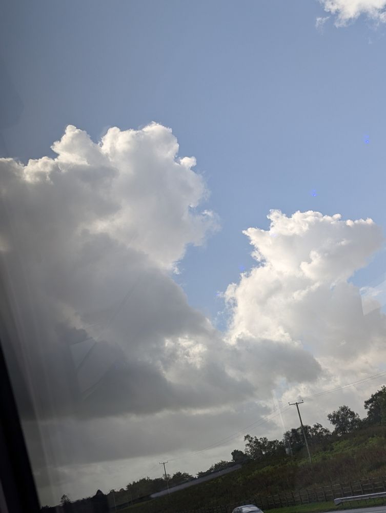 Cloud photograph, the cloud on the left looks like Winnie the Pooh looking to the right, and the cloud on the right looks like Yoda facing towards the camera.