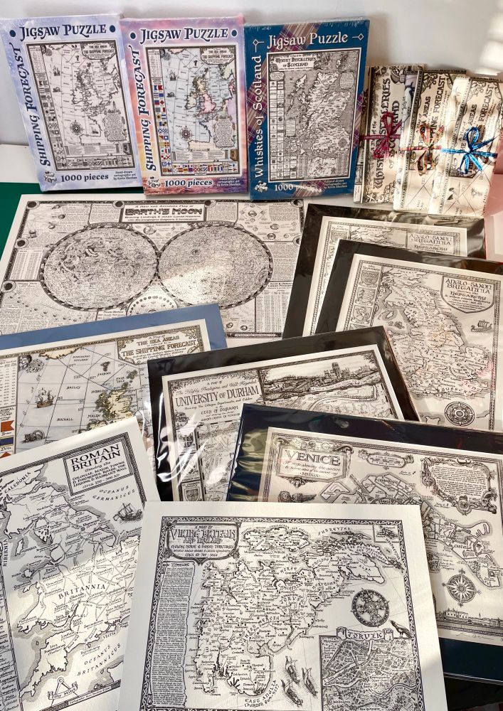 A selection of maps by Manuscript Maps, including puzzles, tea towels, and map prints.