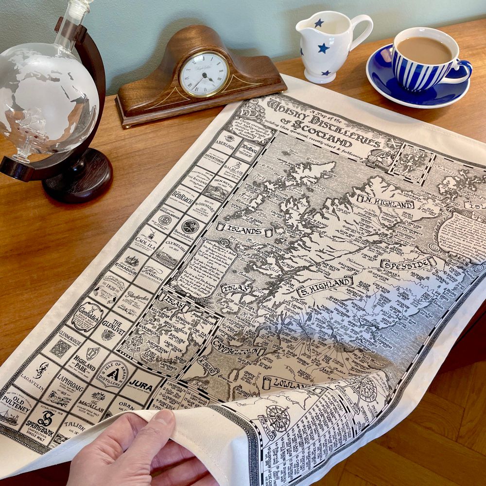 Picture of the Scotland Whisky Map tea towel draped over a sideboard.