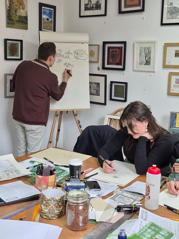 Photo of cartographer Kevin Sheehan demonstrating how to draw settlements at a workshop by Manuscript Maps.