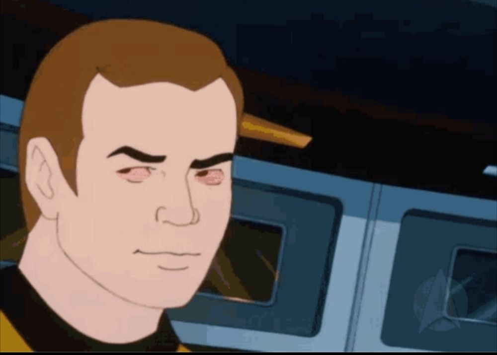 Captain Kirk from Star Trek TAS The Animated Series, he's looking to his side and his eyes are red. He looks stoned as hell