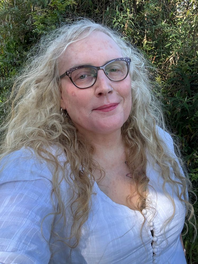 Photo of the post author. A woman in her 50’s standing outdoors.