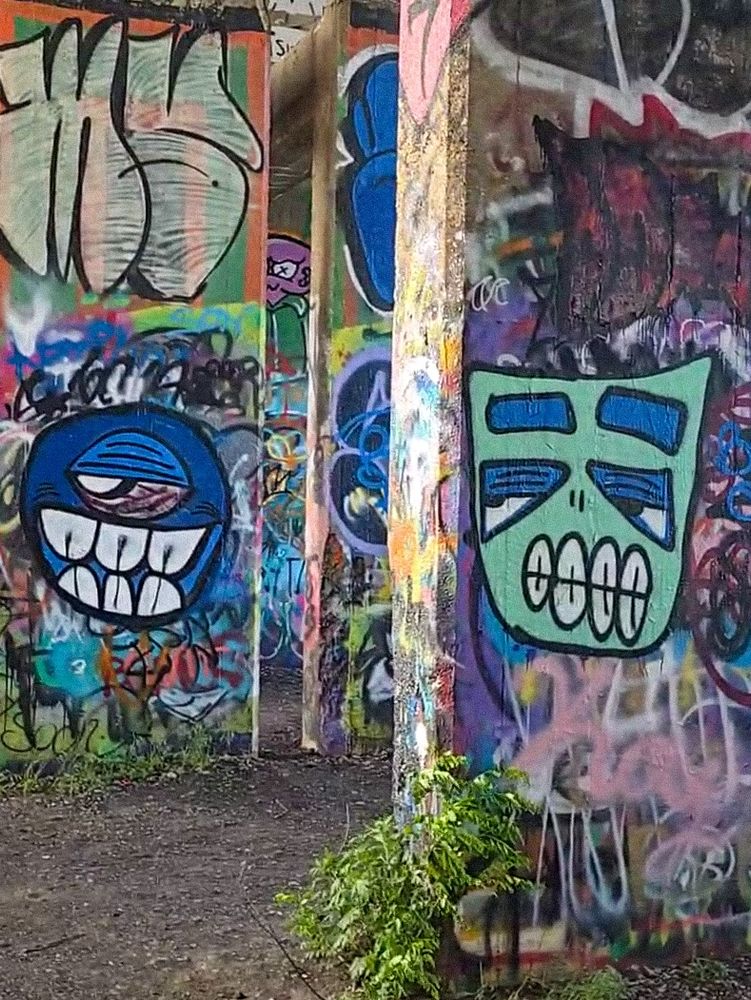 Abstract faces in colorful layered paint street, art