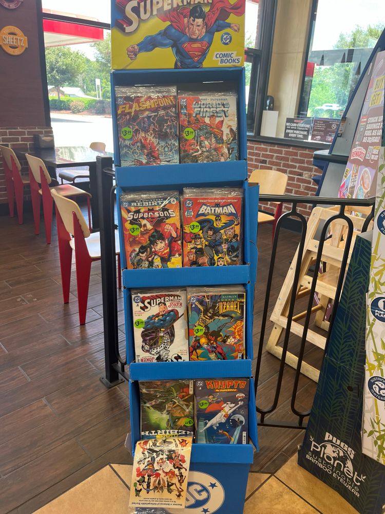 A rack filled with DC Comics at a gas station.