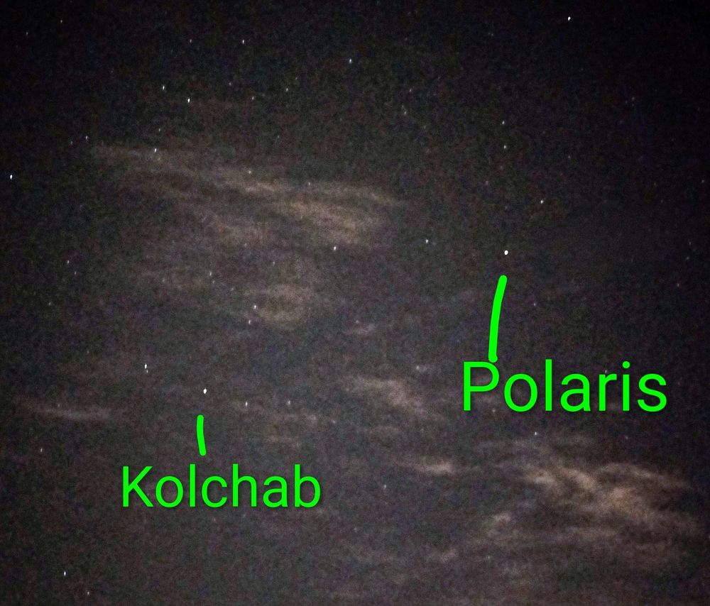 A dark sky with some thin clouds. Two separate stars (the brightest ones in the view) are labelled with their names. The image was created/edited on my cellphone.