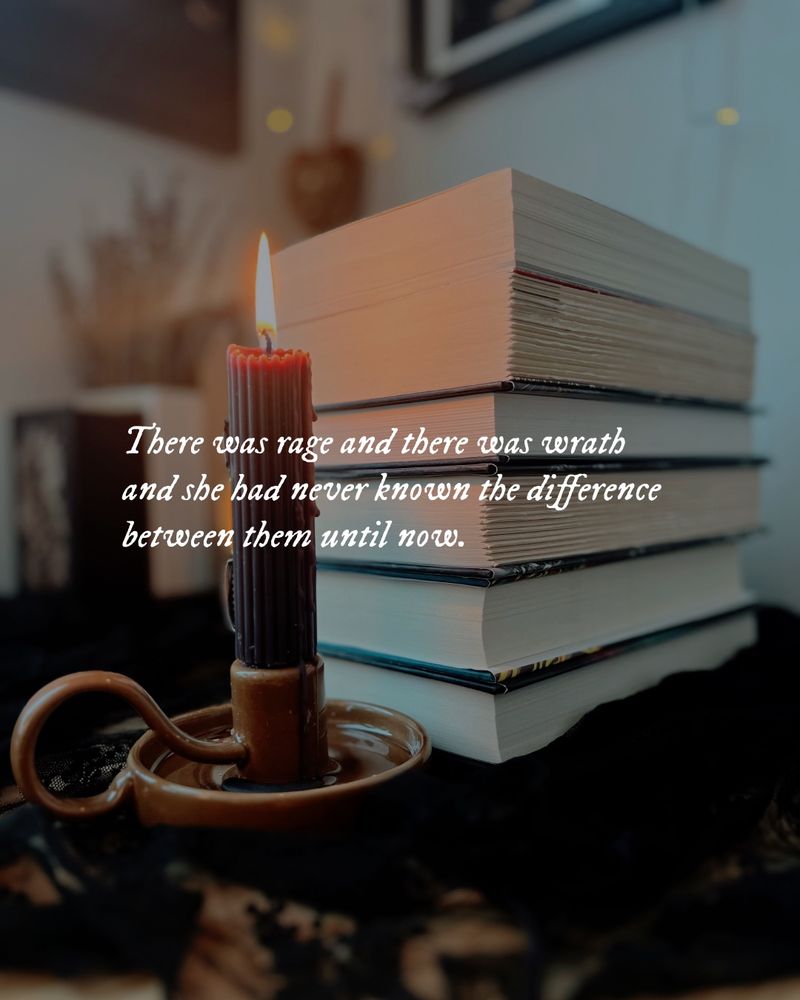 "There was rage and there was wrath and she had never known the difference between them until now." In the backdrop are a stack of books and a lit black candlestick