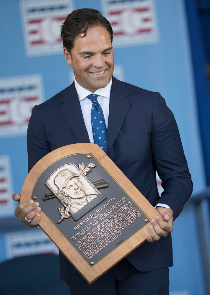 mike piazza holding his well deserved hall of fame plaque 