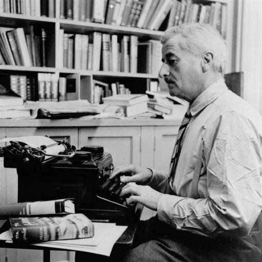 Photo of novelist William Faulkner at his typewriter. 