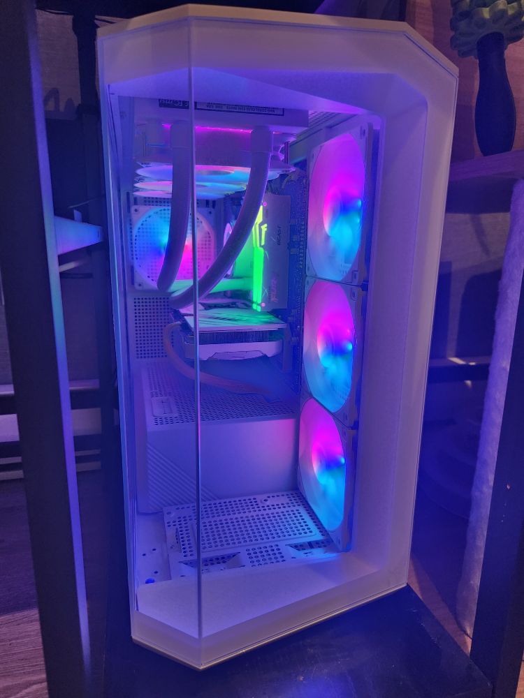 Less awkward photo of the front of a sick ass computer tower. (Pink, blue and green lights)