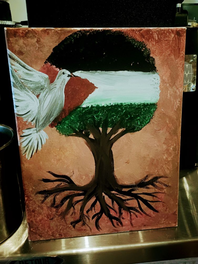 A painting on canvas of a tree, with the Palestinian flag overlaying the top of the tree and its leaves, and a white dove in the left corner