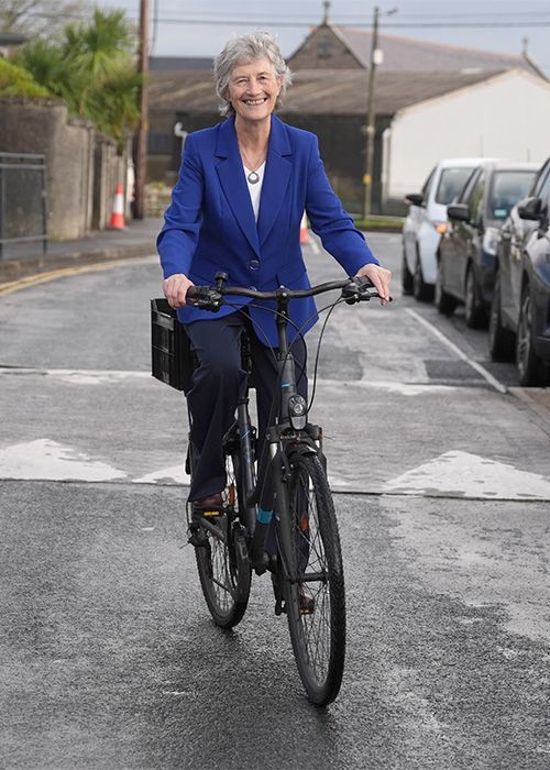 Photo of Catherine Connolly cycling to the polling station on Friday