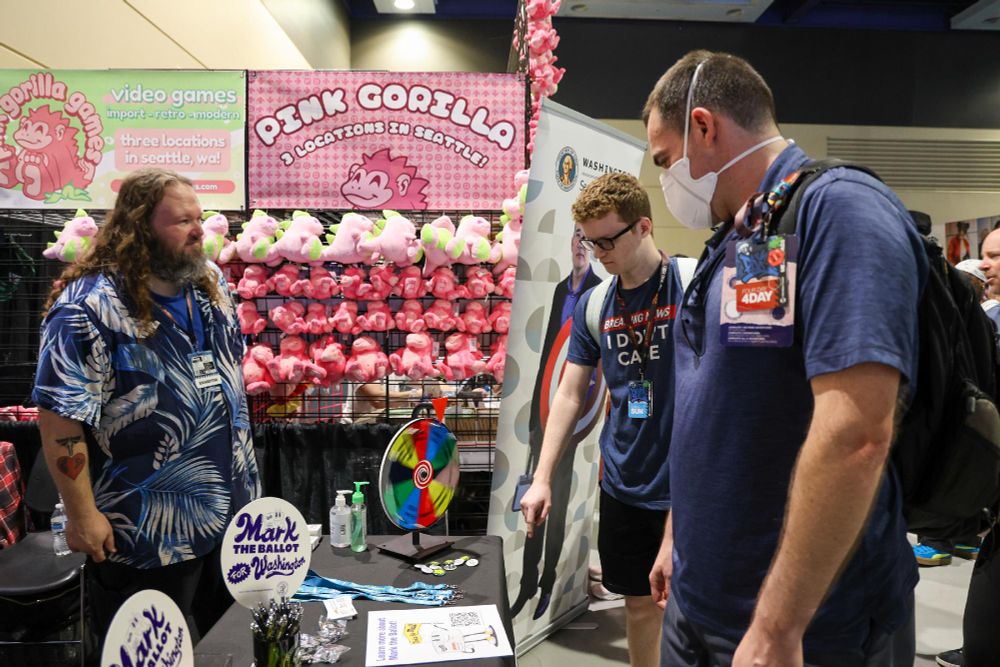 Image at a PAX West gaming convention, where OSOS staff are interacting with attendees. 