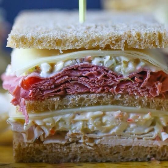 A New Jersey Sloppy Joe sandwich. A double decker with corned beef, turkey cheese and cole slaw.