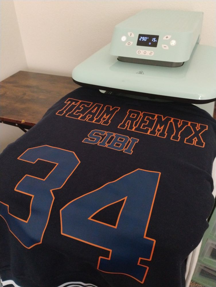 Picture of the back of a dark blue varsity jacket with Team Remix at the top, Sigh bye in the middle, and a large number 34