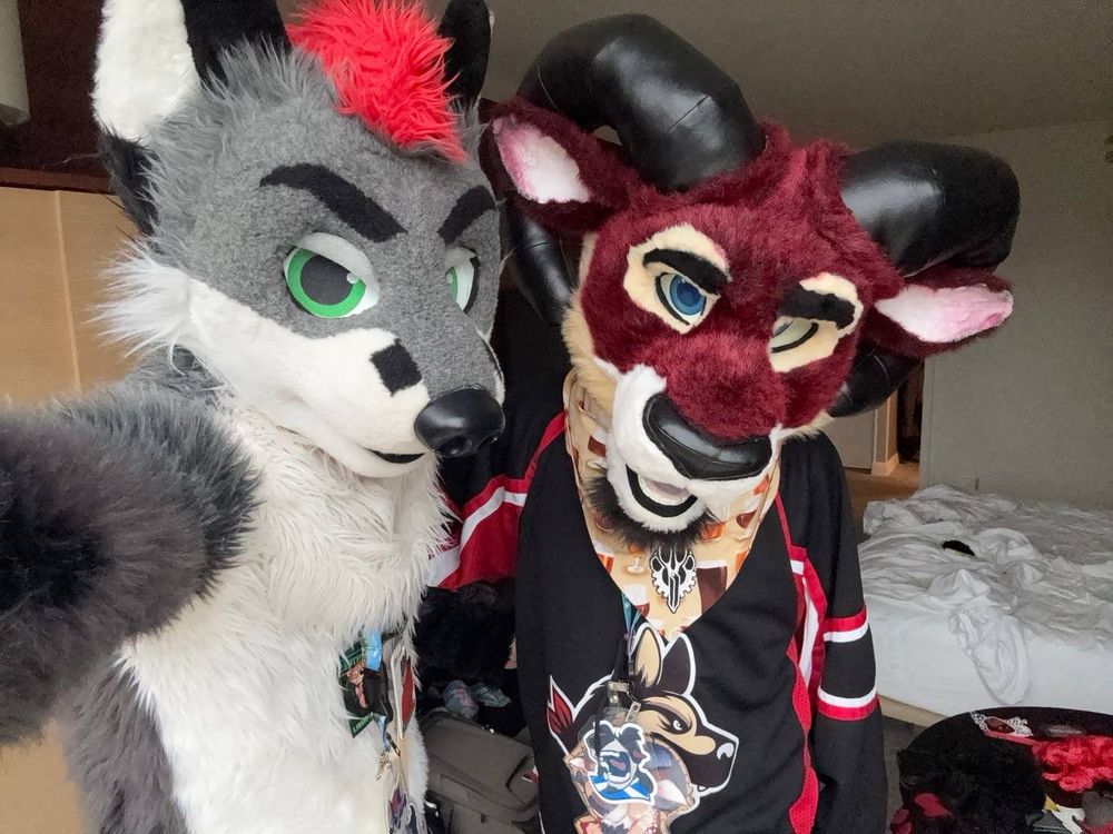 Selfie of two fursuiters. One fox named Martini and one ram named Saxon.