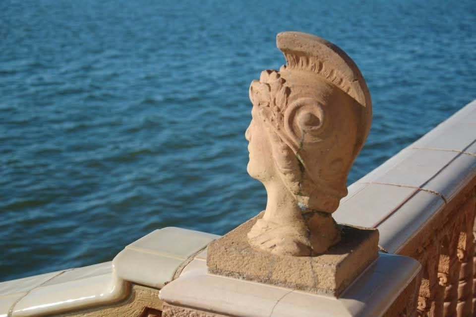 A granite sculpture of the head of a Roman Gladiator looks out across the Pacific Ocean, a silent sentry over the centuries.