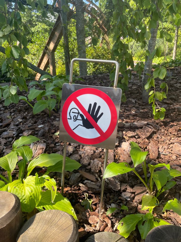 A sign with a man with his hand out 