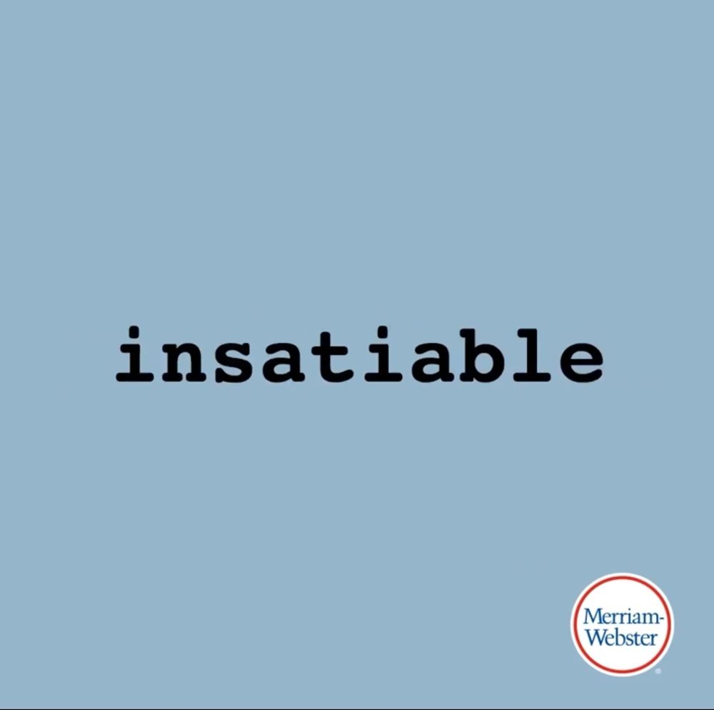 A pale blue background, with a Merriam-Webster logo in the bottom right corner. The word "insatiable" is in the middle of the picture. 