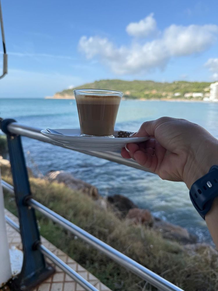 Coffee cup with the sea in the background. 