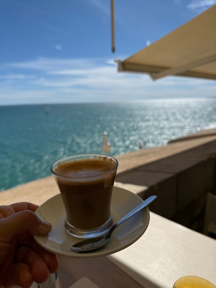 Cortado coffee by the Mediterranean Sea.