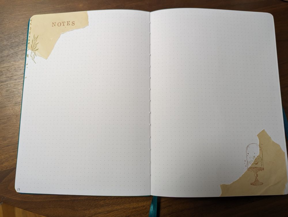 "notes" page. Tea-stained paper, stamped with a branch on one side and a bee in the case in the other. Most of the spread is blank for note-taking