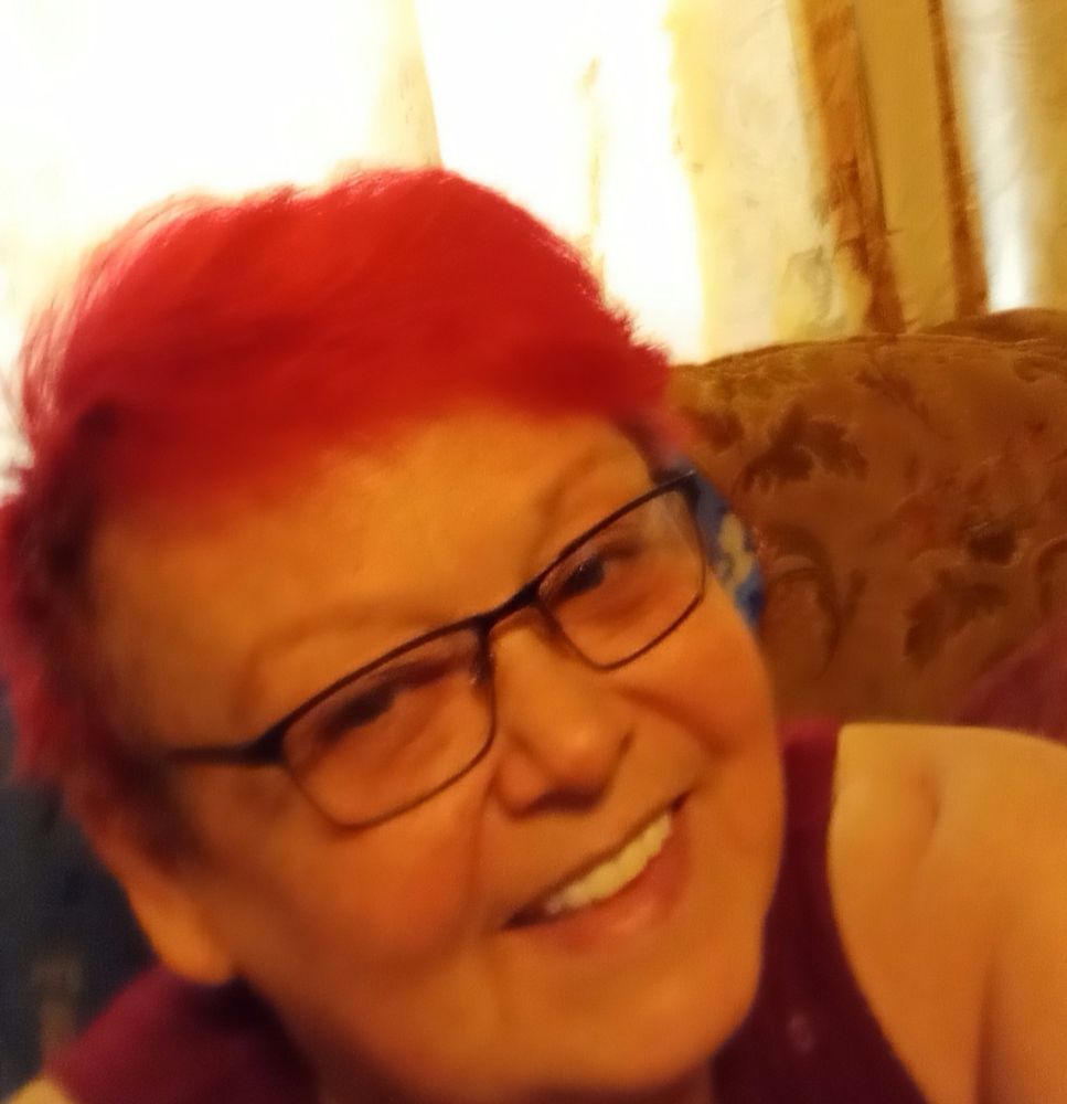 Me at 65 with magenta hair and glasses