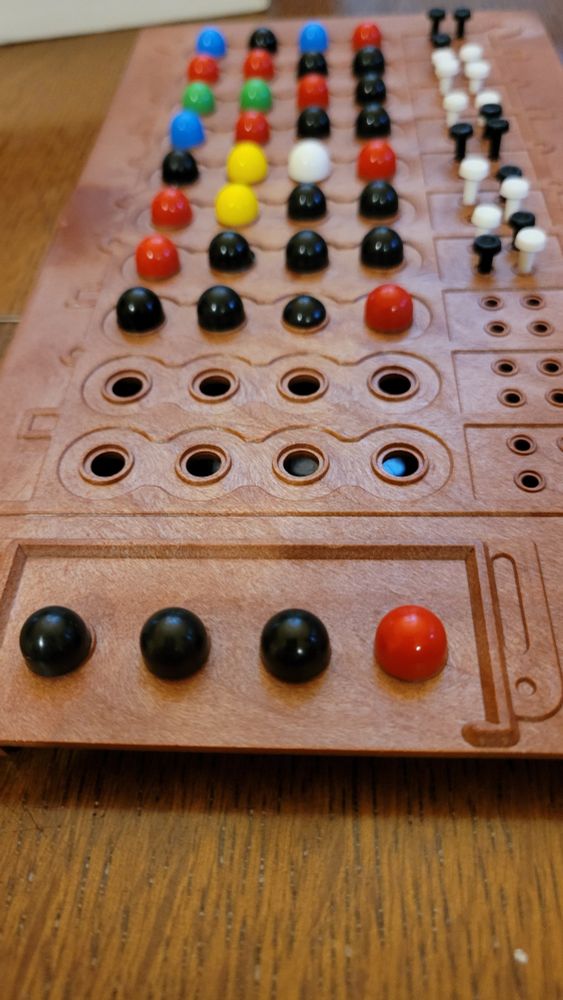 Mastermind board game showing a complete board after 8 moves. 