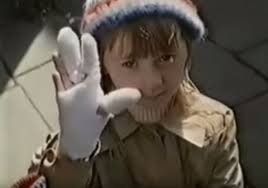 A still from the old UK public information film about the dangers of fireworks. A young girl is holding up a heavily bandaged hand to the camera