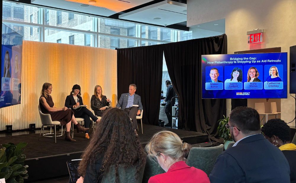 Four speakers on a stage at an event
