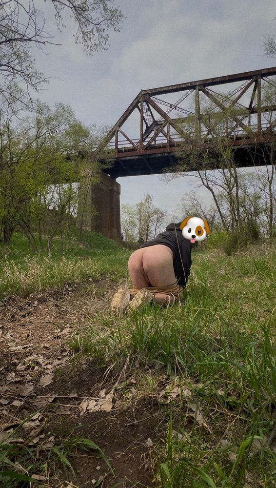 Man with a puppy sticker over his face naked posing in nature