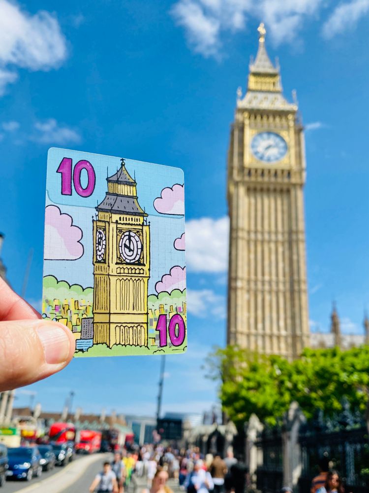 A card from Sky Towers of Big Ben next to the real Big Ben.