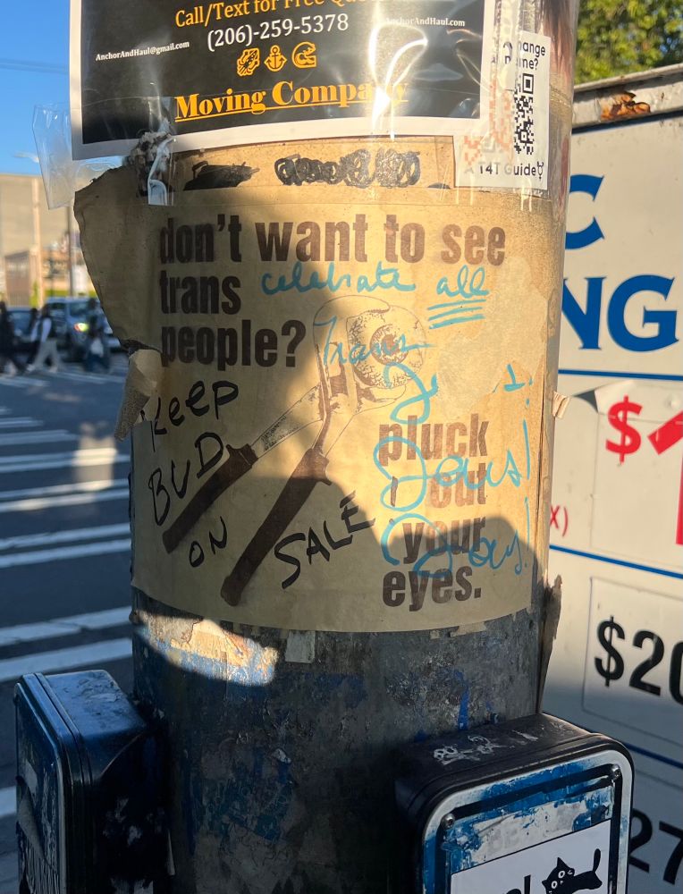 A poster that says “don’t want to see trans people? Pluck out your eyes.” 