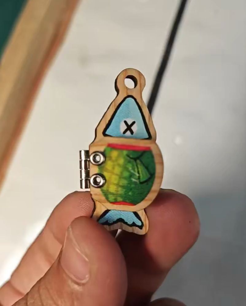 A hinged wooden fish keychain 