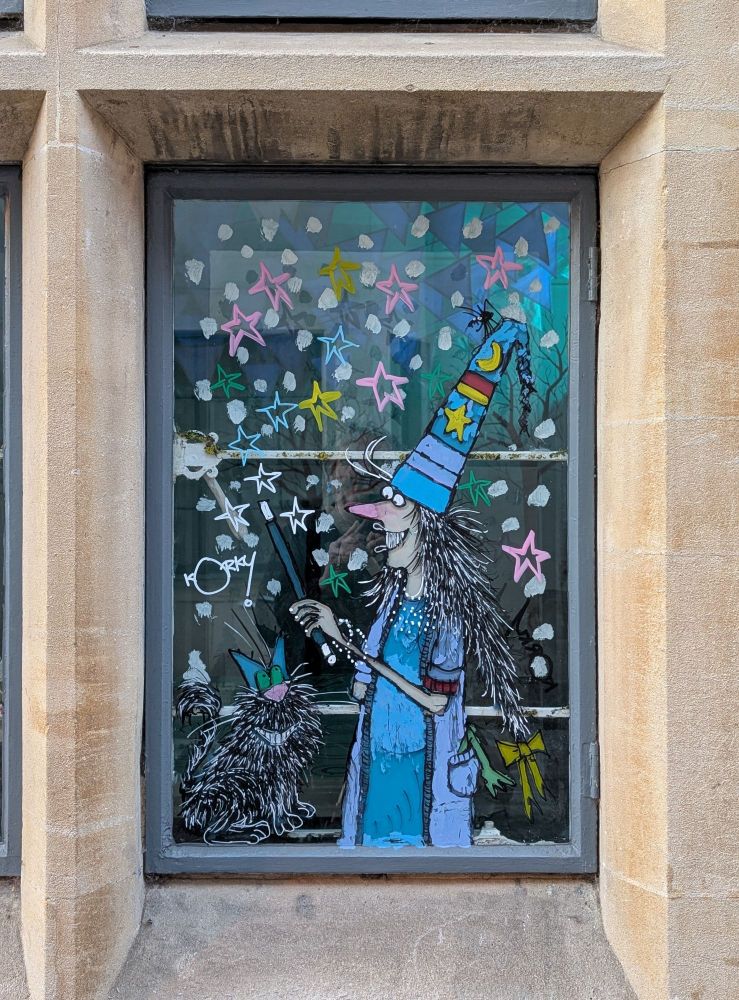 A window in the Story Museum in Oxford. 
It has been painted by the artist Korky Paul, and depicts his character, Winnie the Witch, and her cat, Wilbur.