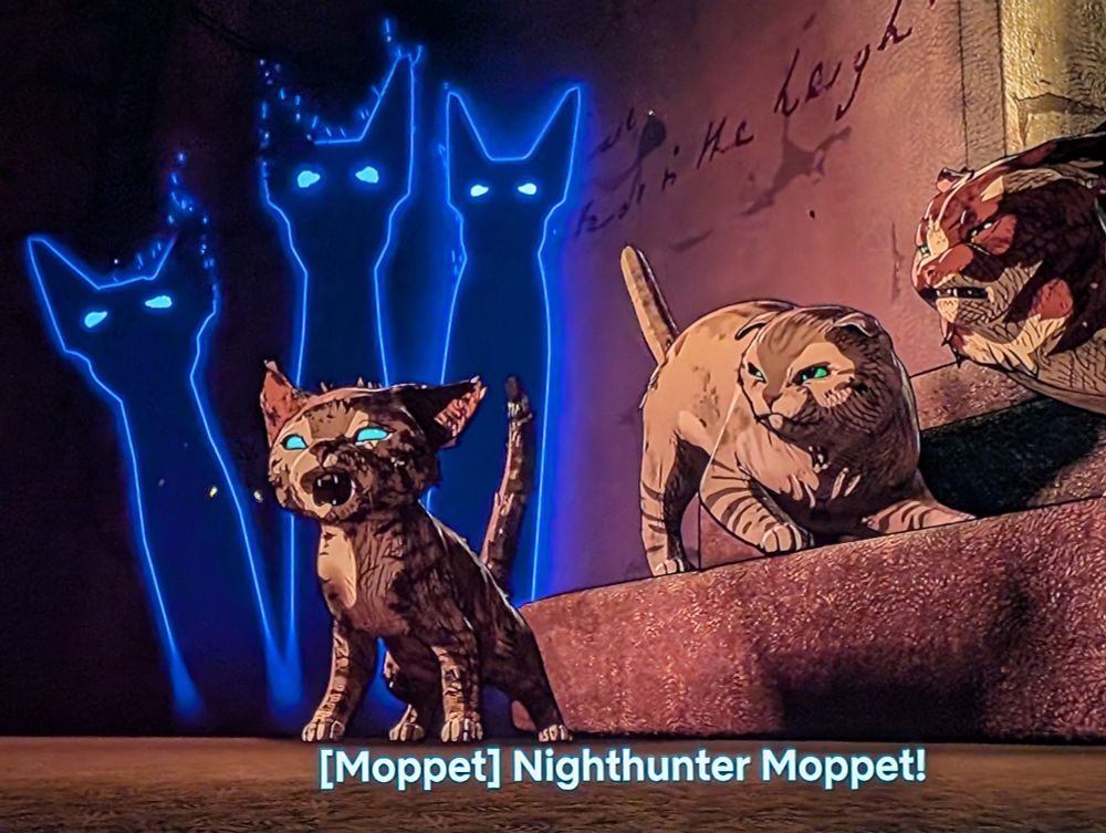 Two cats and a kitten called Moppet, backed by three ghostly silhouette cats. 
Moppet is yelling "Nighthunter Moppet!".