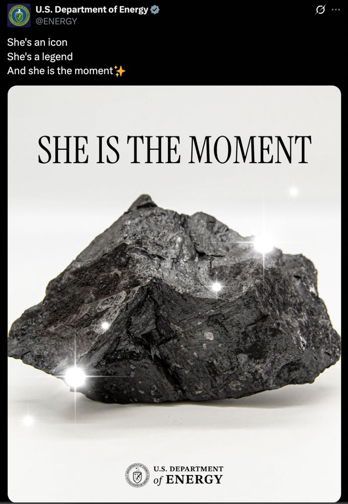 A tweet from the Energy Department showing a piece of coal and the text "she is the moment." There's a sparkle effect on the coal