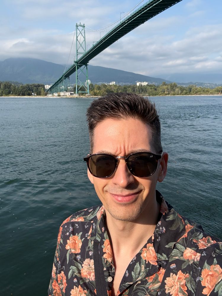 Aaron, standing on Vancouver’s seawall near the Lion’s Gate Bridge.