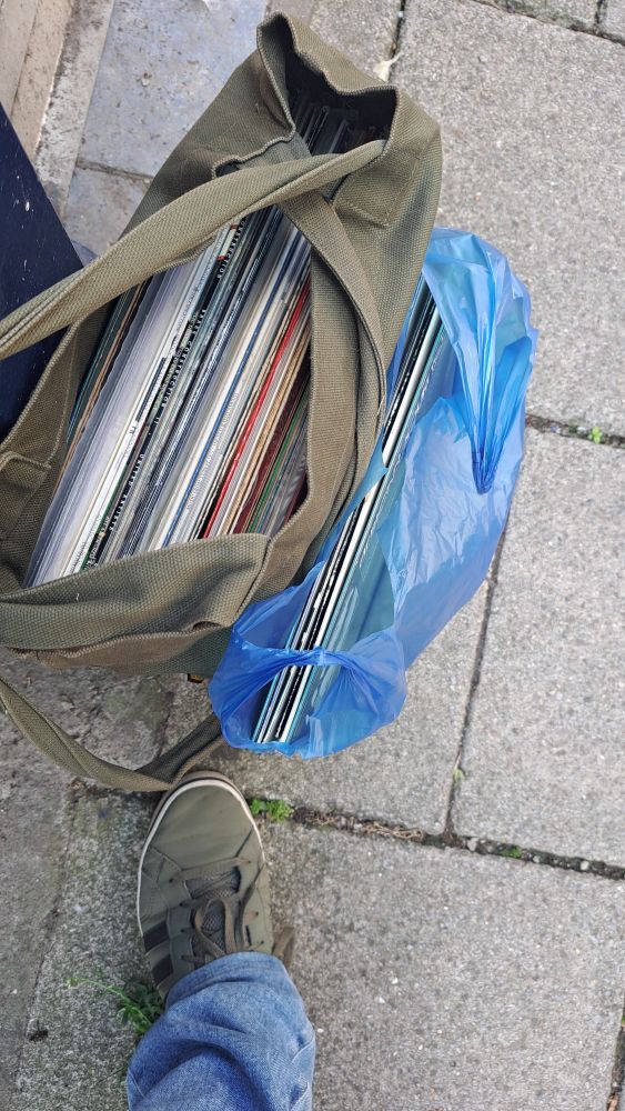 Two bags containing an obscene amount of vinyl records. Like, 50 or so.