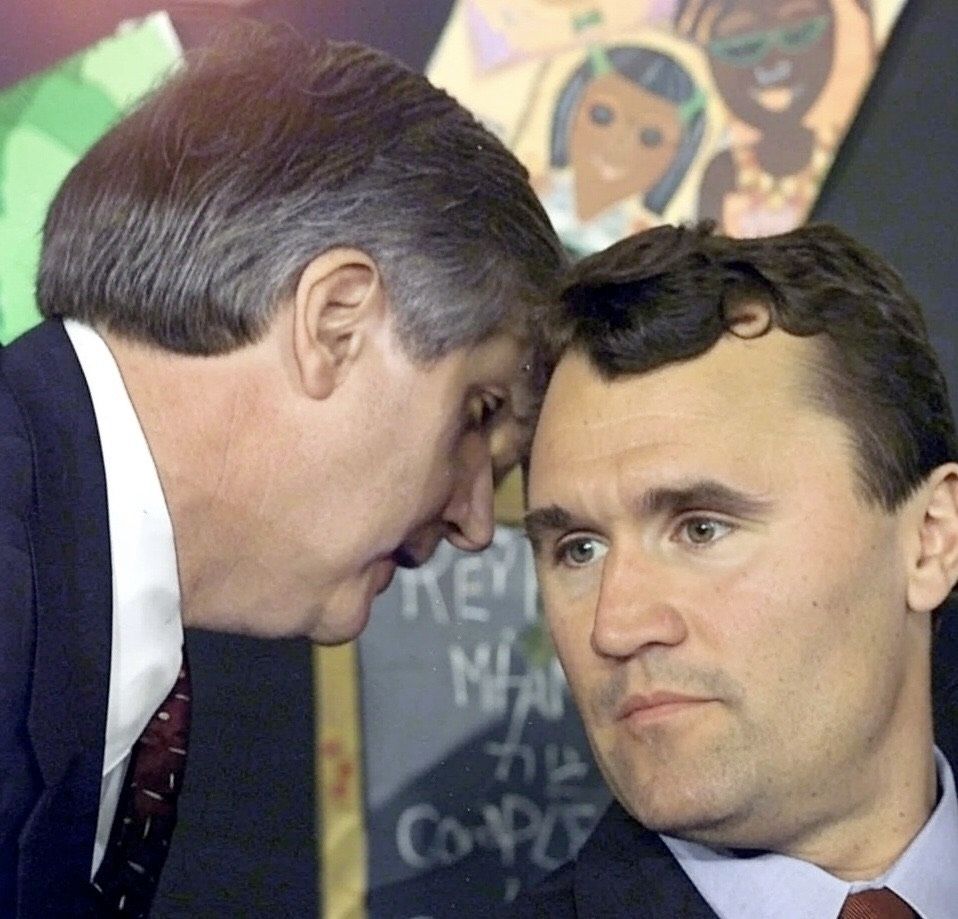 An edited image of charchar on George Bush's face in the classic meme of the secretary whispering in his ear