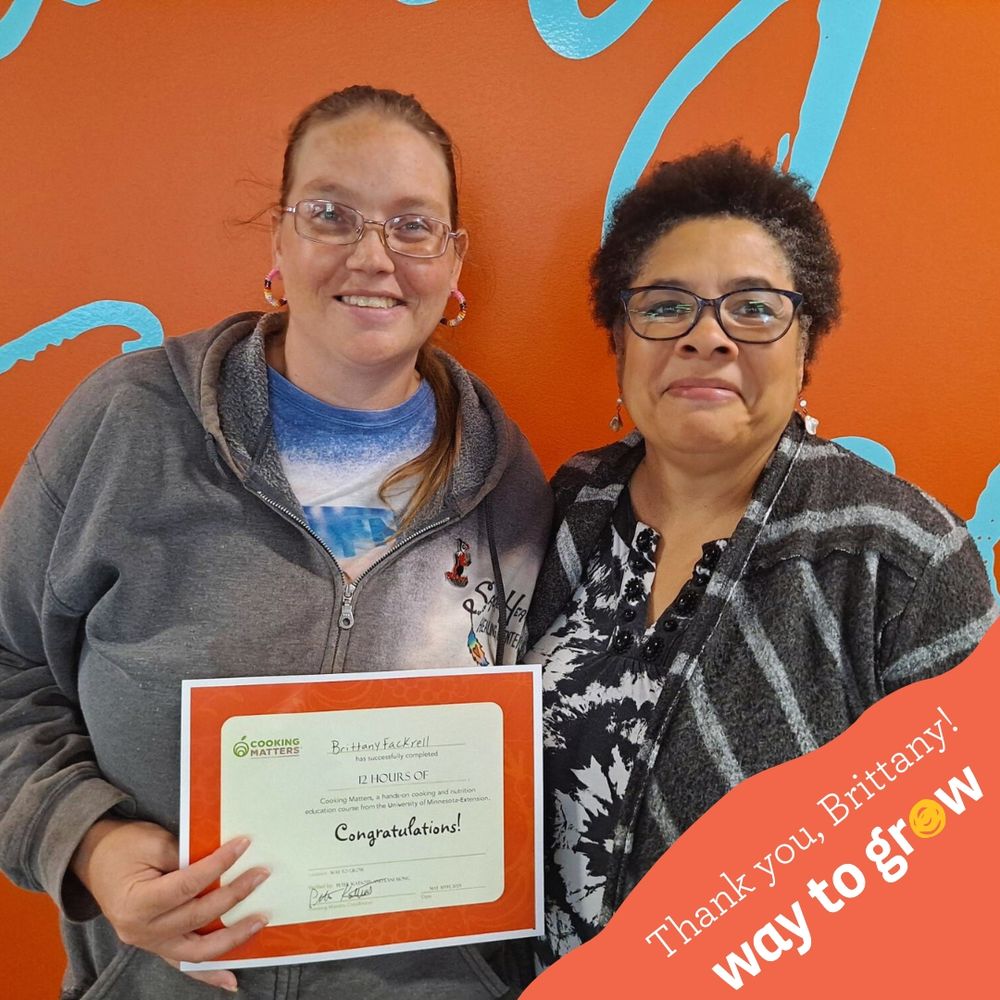 Brittany and Ronel smiling with Brittany’s cooking certificate