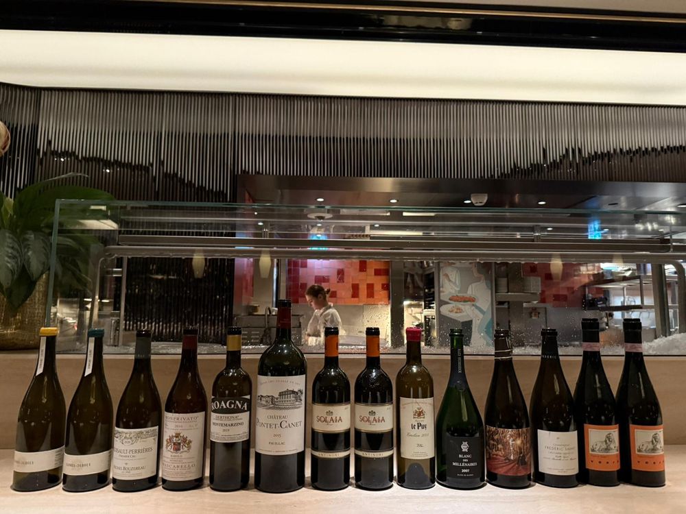 A lineup of empty wine bottles