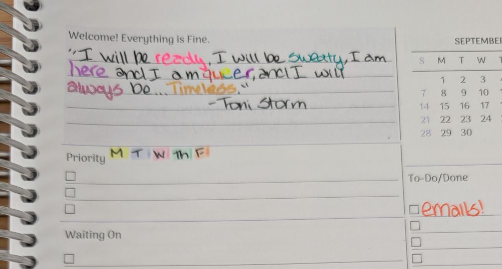 Picture of a planner with a quote from Toni Storm about being sweaty and queer.