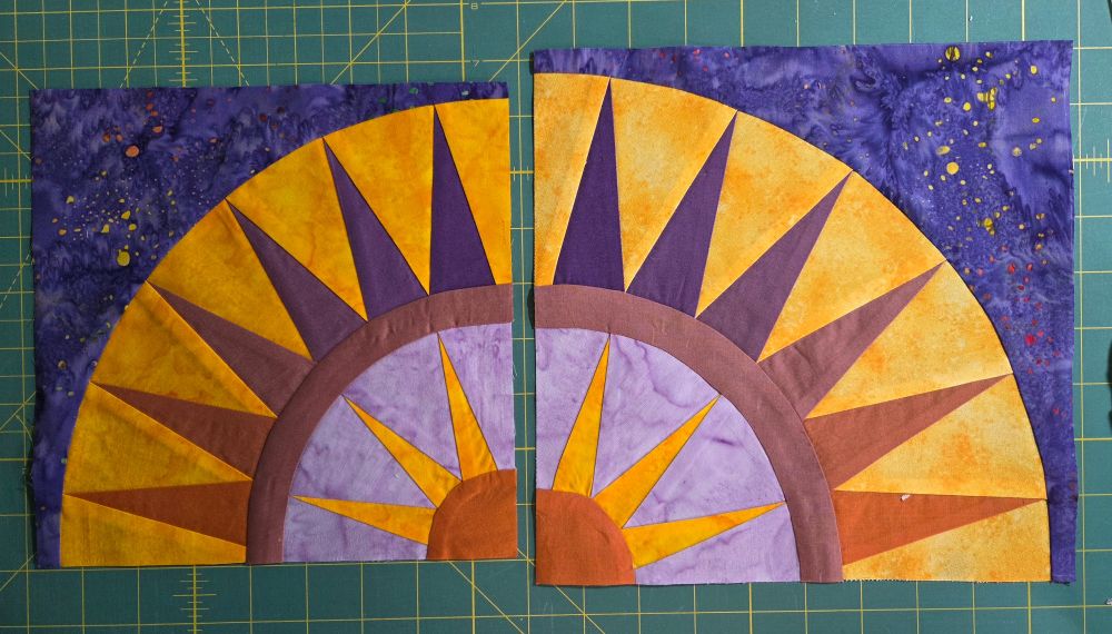 2 New York Beauty quilt blocks, the same except mirror images and one is 1" bigger in both directions.  Purples, rusts, and golds for the colors.